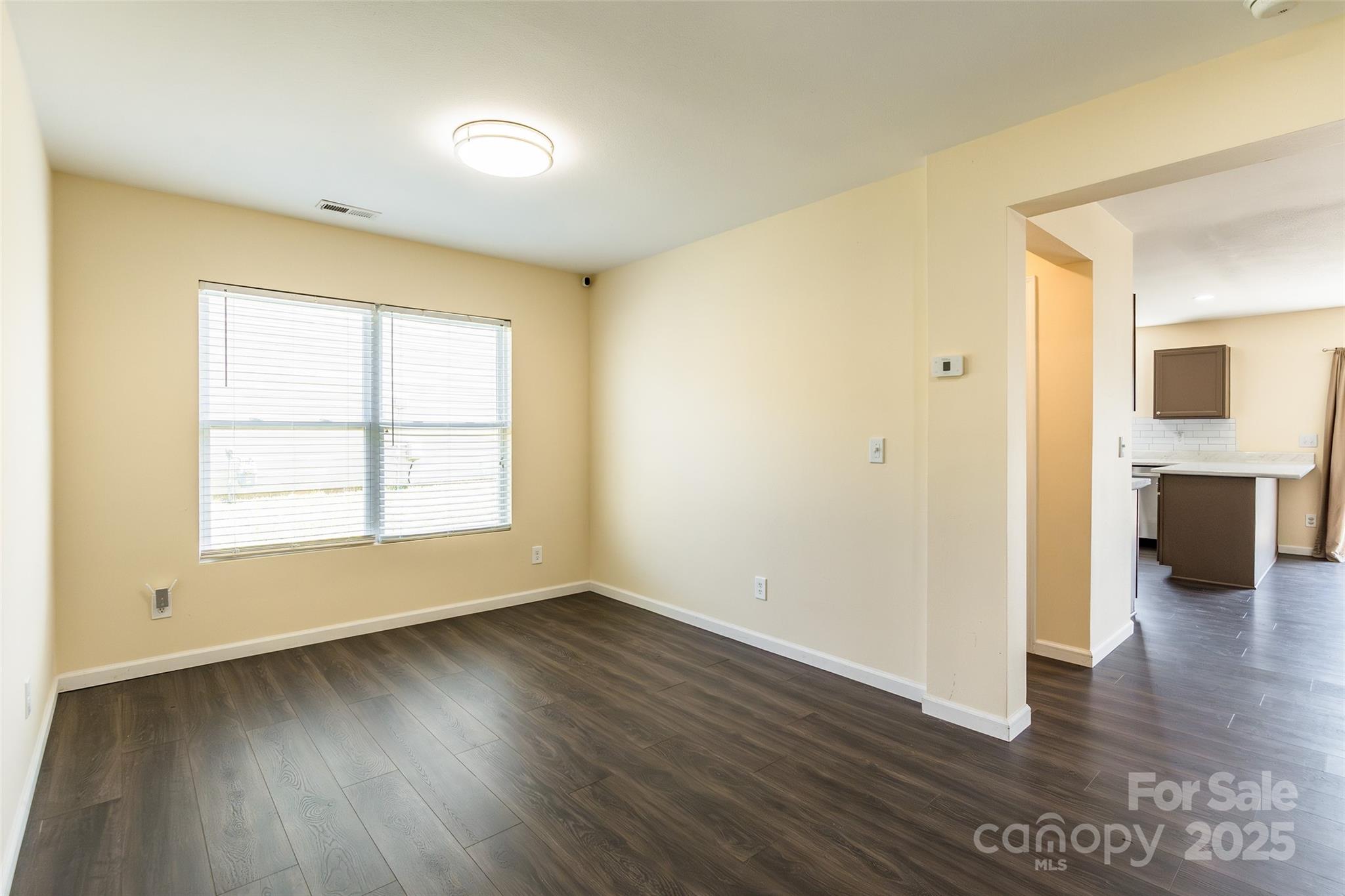 2357 Riding Trail Road Gastonia, NC 28054 - Photo 6 of 32 an empty room with wooden floor and a window