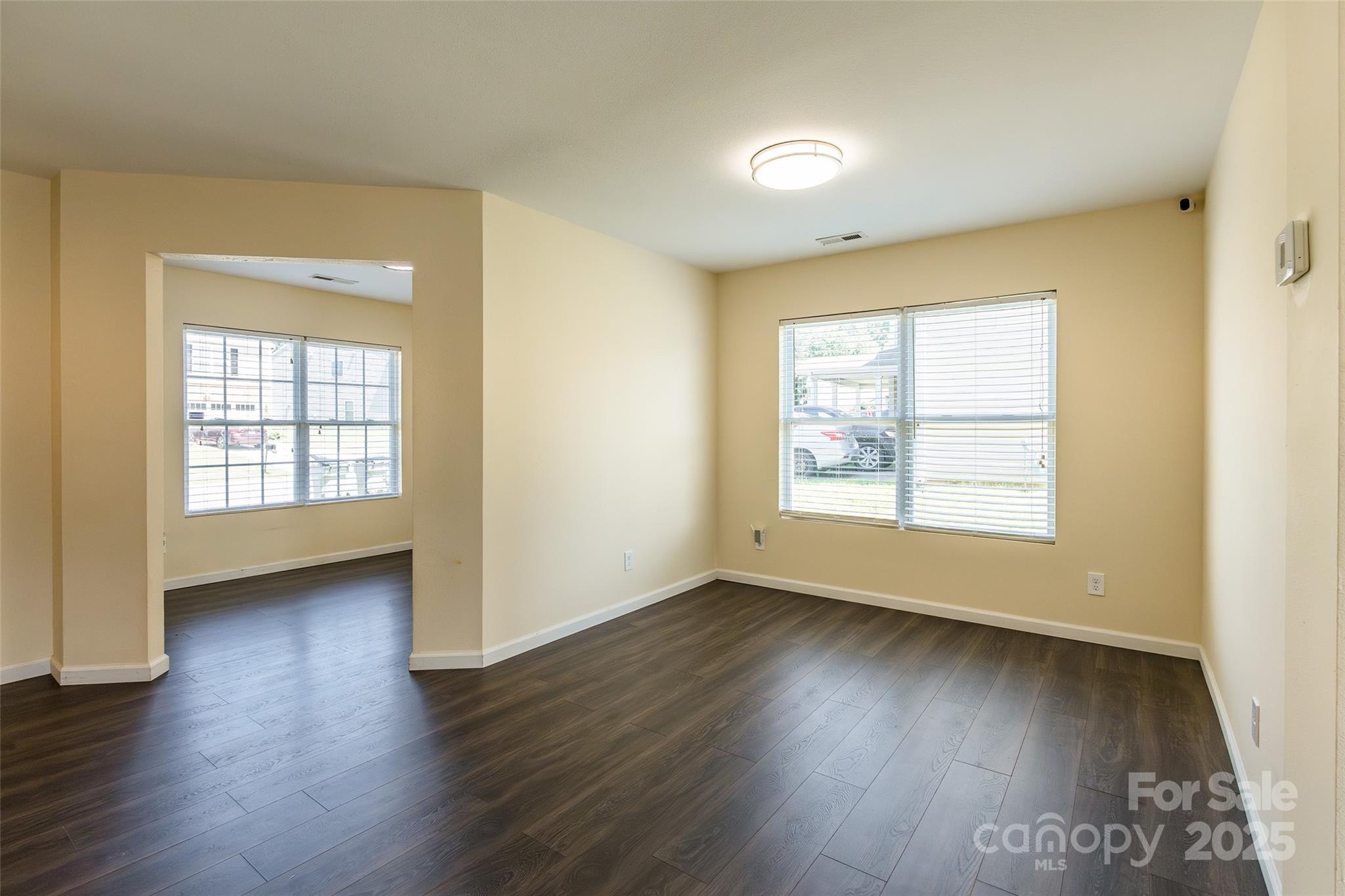 2357 Riding Trail Road Gastonia, NC 28054 - Photo 7 of 32 an empty room with wooden floor and windows