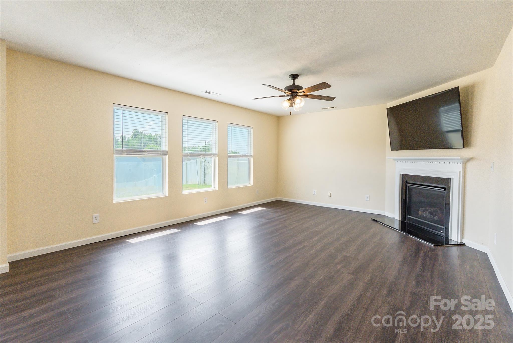 2357 Riding Trail Road Gastonia, NC 28054 - Photo 8 of 32 a view of an empty room with a fireplace and a window