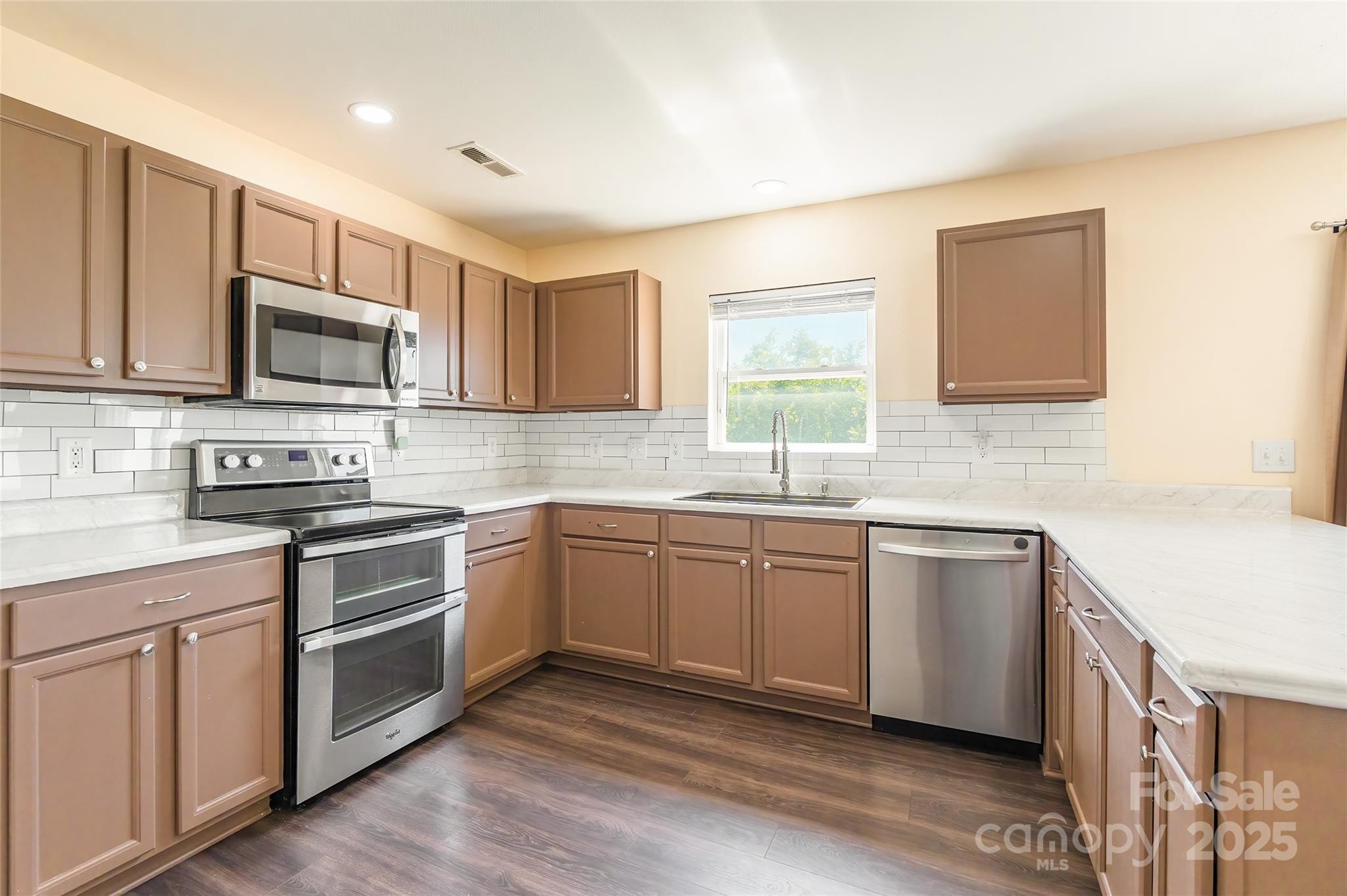 2357 Riding Trail Road Gastonia, NC 28054 - Photo 10 of 32 a kitchen with granite countertop wooden cabinets stainless steel appliances and a window