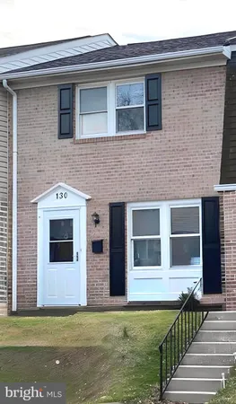 a front view of a house with large windows