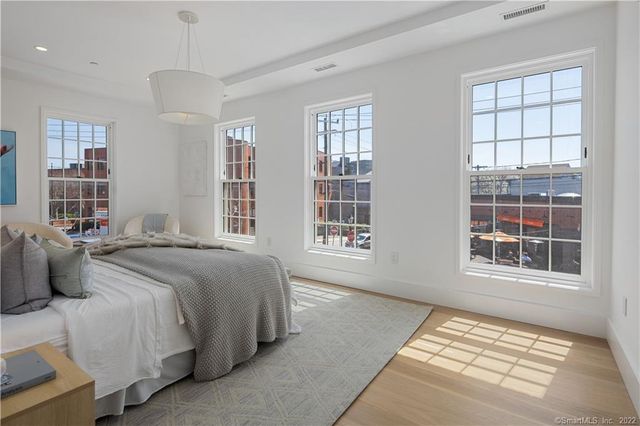 a spacious bedroom with a bed and a window