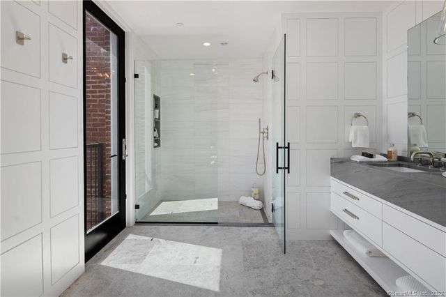 a bathroom with a granite countertop sink mirror and shower