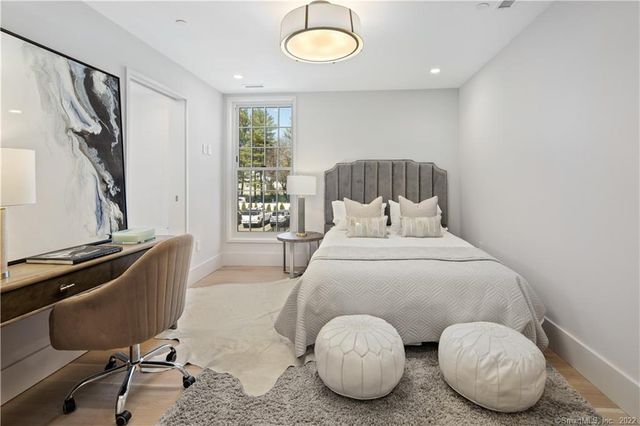 a bedroom with a bed and a chair