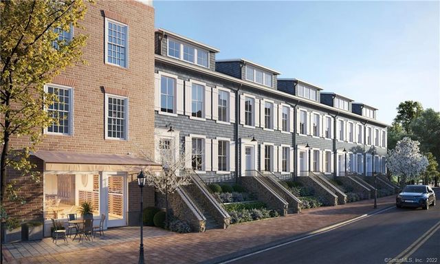 a view of a brick house with many windows