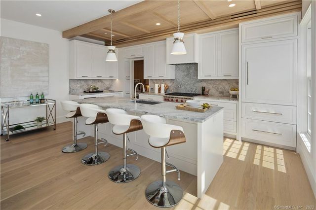 a kitchen with stainless steel appliances granite countertop a sink and cabinets