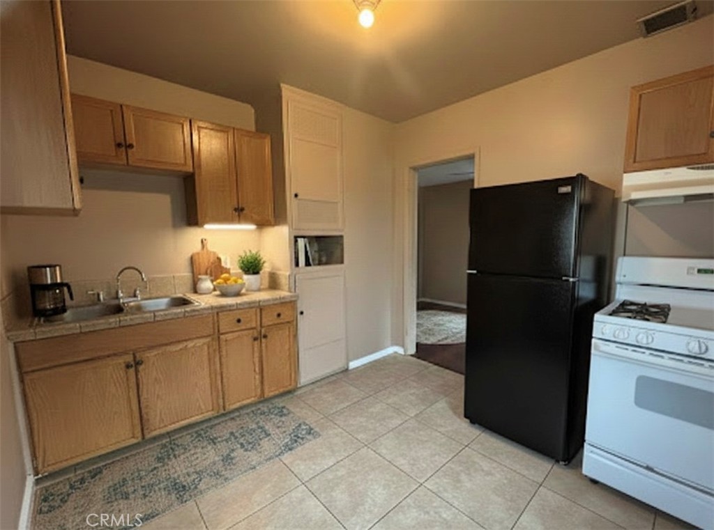 3850 Dwight Avenue Riverside, CA 92507 - Photo 2 of 6 a kitchen with a refrigerator and a sink