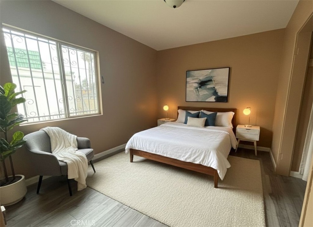 3850 Dwight Avenue Riverside, CA 92507 - Photo 5 of 6 a bedroom with a bed and wooden floor