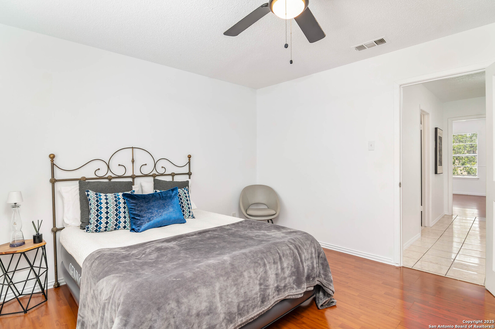 911 Vance Jackson Road, Unit A San Antonio, TX 78201 - Photo 16 of 20 a bedroom with a bed and wooden floor