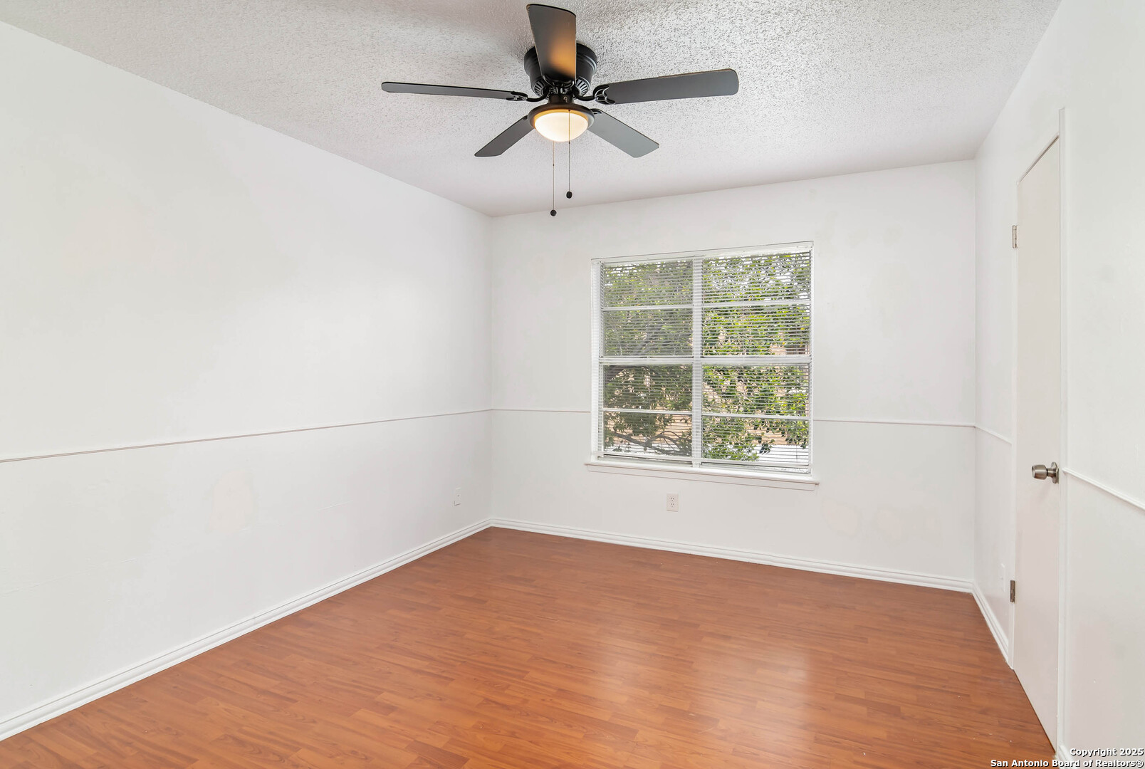 911 Vance Jackson Road, Unit A San Antonio, TX 78201 - Photo 18 of 20 an empty room with a window and a fan