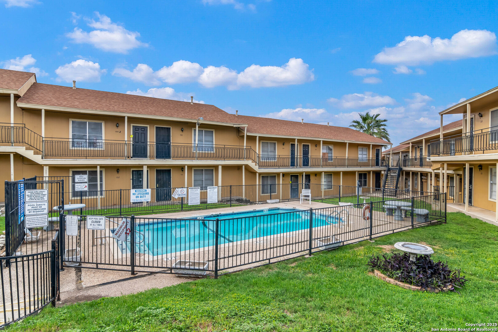 911 Vance Jackson Road, Unit A San Antonio, TX 78201 - Photo 19 of 20 a view of a brick building next to a yard