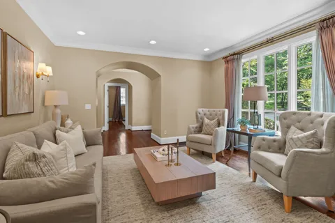 an empty room with wooden floor and a ceiling fan