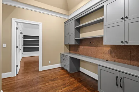 a bathroom with a granite countertop toilet sink vanity and mirror
