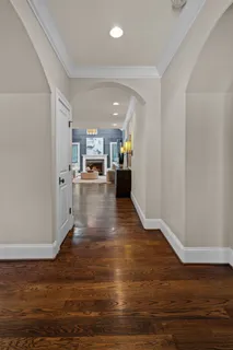 a view of an empty room with wooden floor and closet