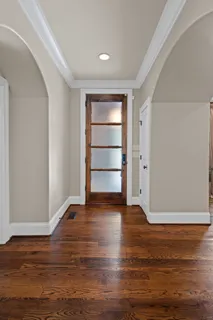 a bed sitting in a spacious bedroom next to a window