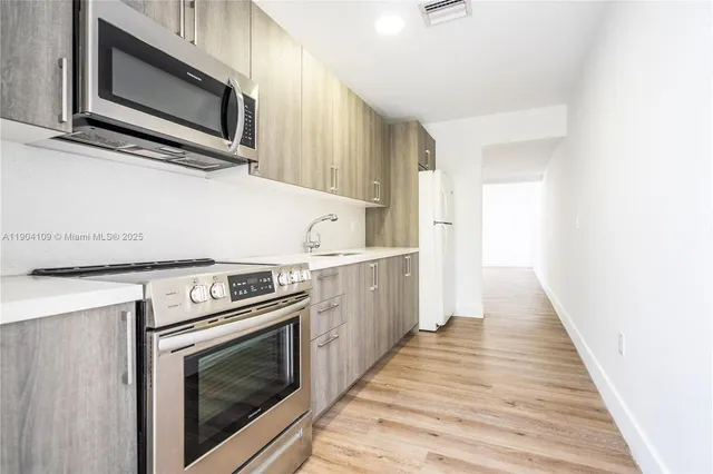 a kitchen with a stove microwave and sink