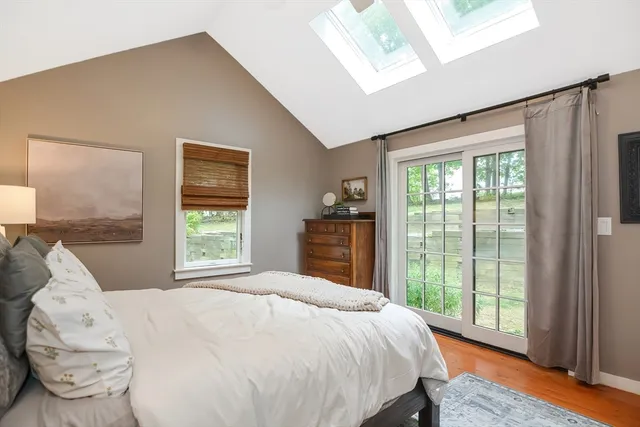 a large bed sitting in a bedroom next to a window