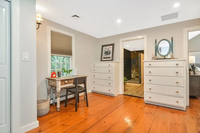 a view of a bedroom with furniture and window