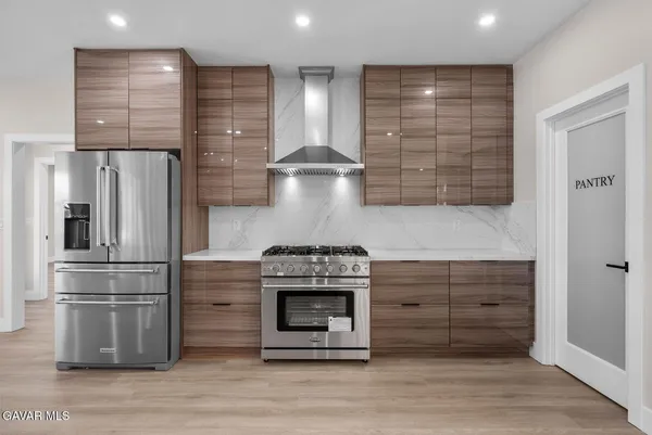 a kitchen with granite countertop a stove and a refrigerator