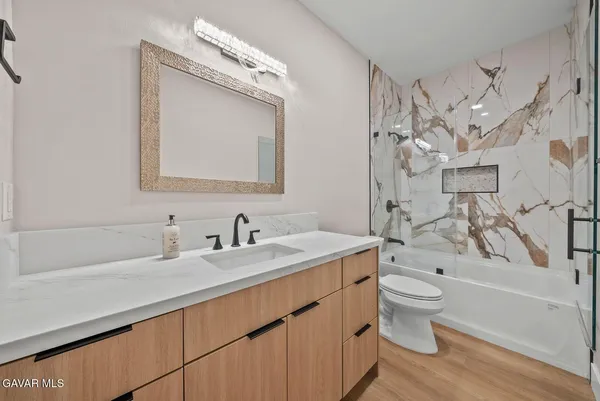 a bathroom with a sink a toilet and bathtub