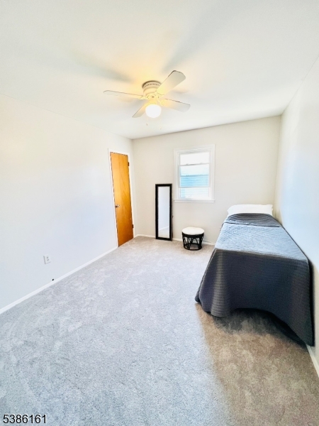 341 Trotting Road Union, NJ 07083 - Photo 20 of 24 a bedroom with a bed and a chandelier