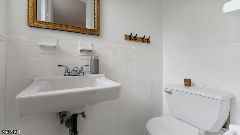 341 Trotting Road Union, NJ 07083 - Photo 8 of 24 a bathroom with a sink mirror and toilet