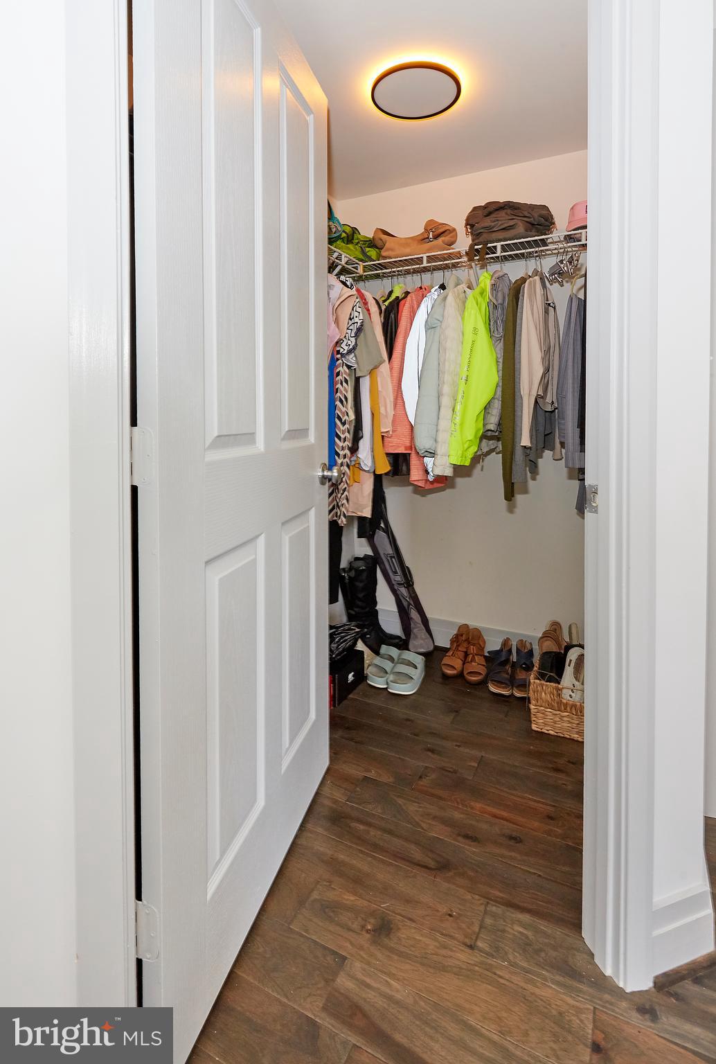 414 Water Street, Unit 2601 Baltimore, MD 21202 - Photo 22 of 51 a view of walk in closet with clothes and shoes