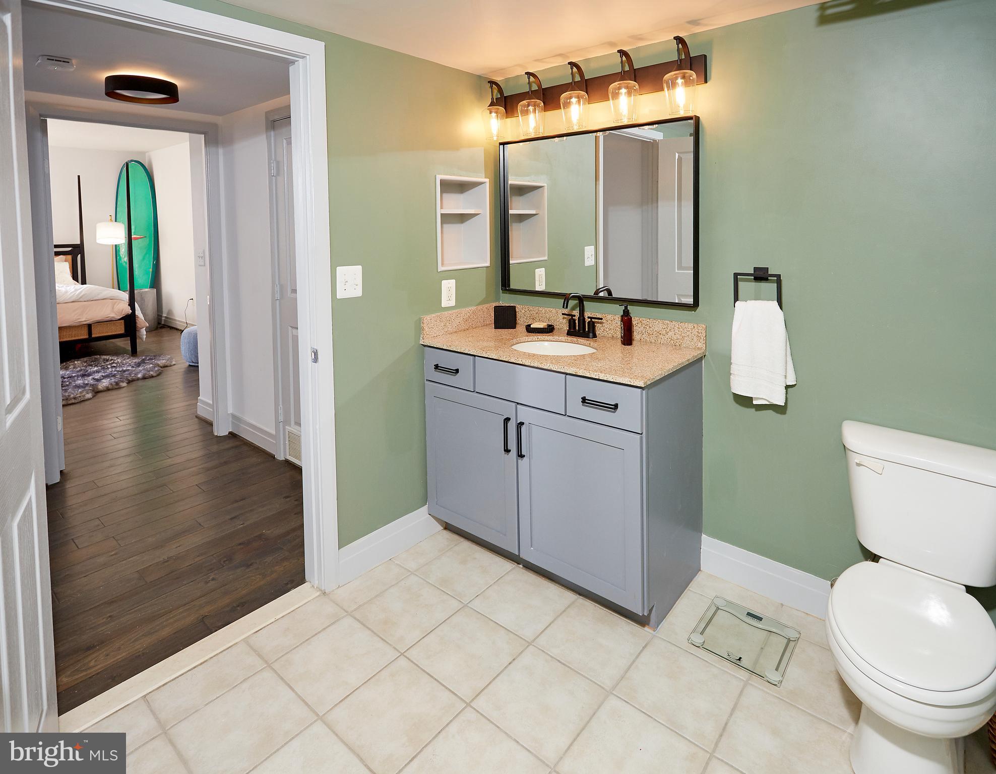 414 Water Street, Unit 2601 Baltimore, MD 21202 - Photo 23 of 51 a bathroom with a sink a toilet and shower