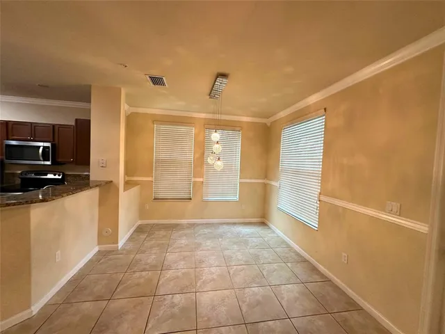 a view of a livingroom with an empty space and a window
