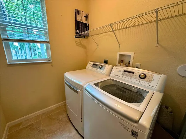 an empty room with a ceiling fan and window