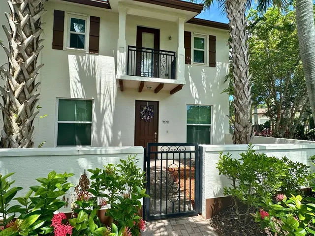 a view of a hallway with wooden floor and a living room