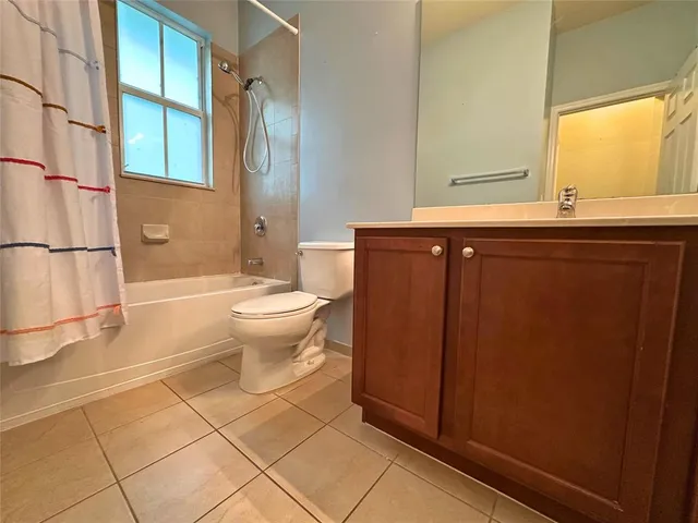 an empty room with a empty space and a ceiling fan