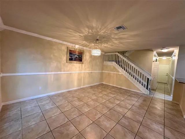 a view of a kitchen with an empty space and a window