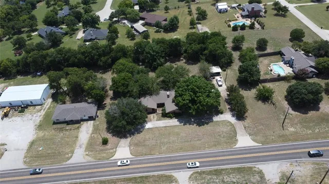 an aerial view of a house with yard