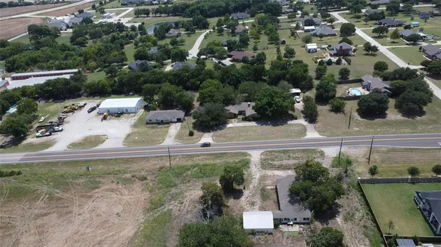 an aerial view of a house with yard
