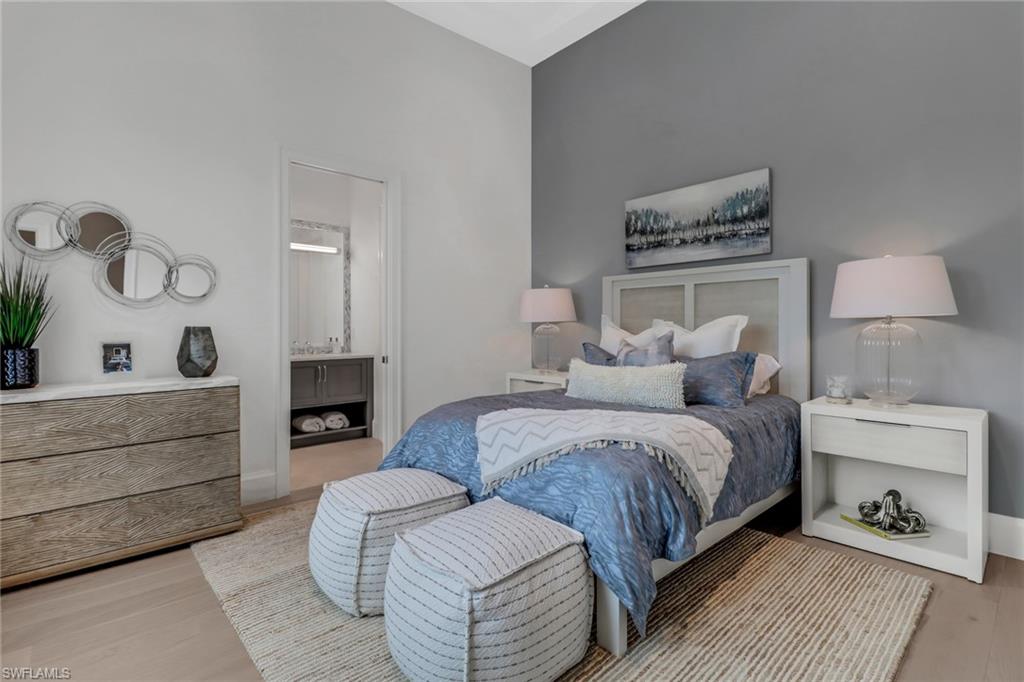 12 Banyan Road Naples, FL 34108 - Photo 20 of 44 a spacious bedroom with a bed and a couch