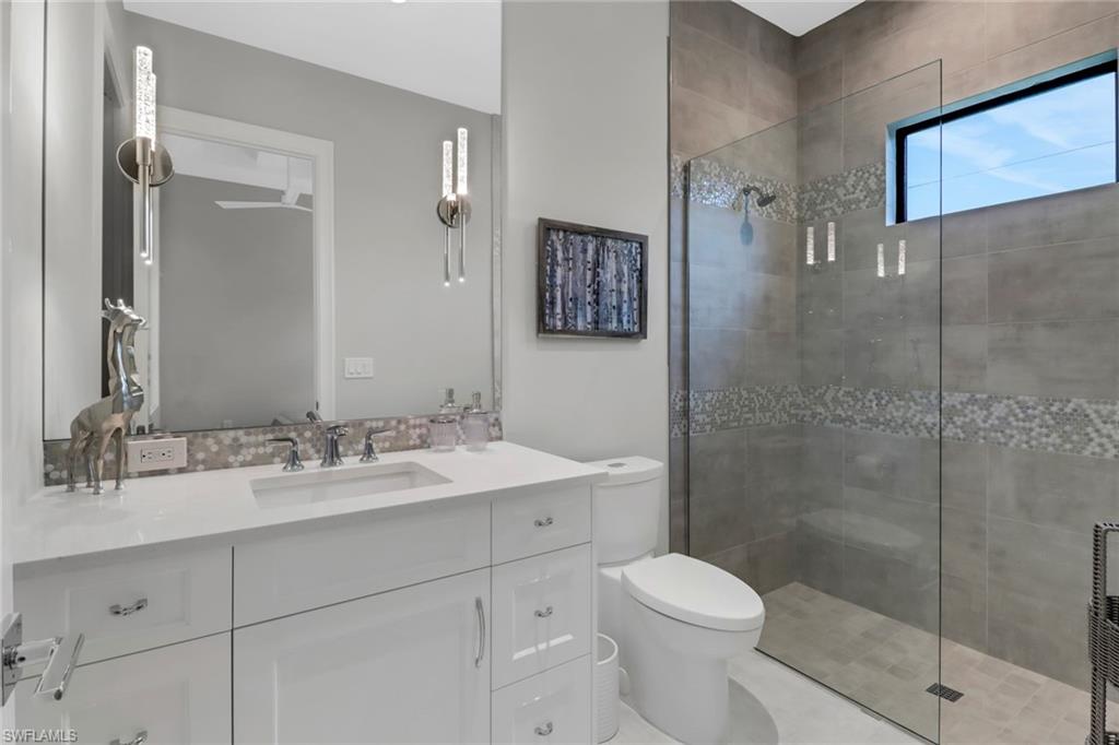 12 Banyan Road Naples, FL 34108 - Photo 25 of 44 a bathroom with a sink toilet and shower