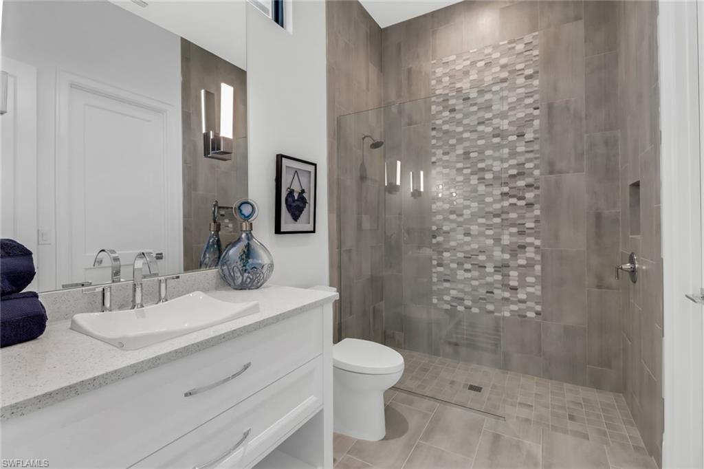 12 Banyan Road Naples, FL 34108 - Photo 32 of 44 a bathroom with a sink a toilet and shower