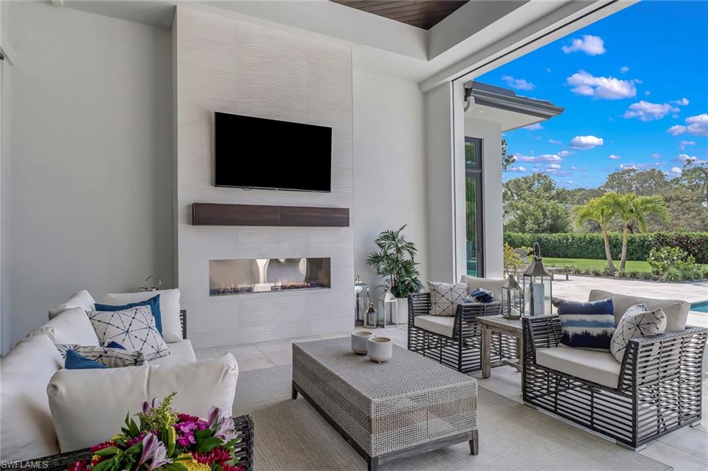 12 Banyan Road Naples, FL 34108 - Photo 35 of 44 a living room with furniture fireplace and flat screen tv