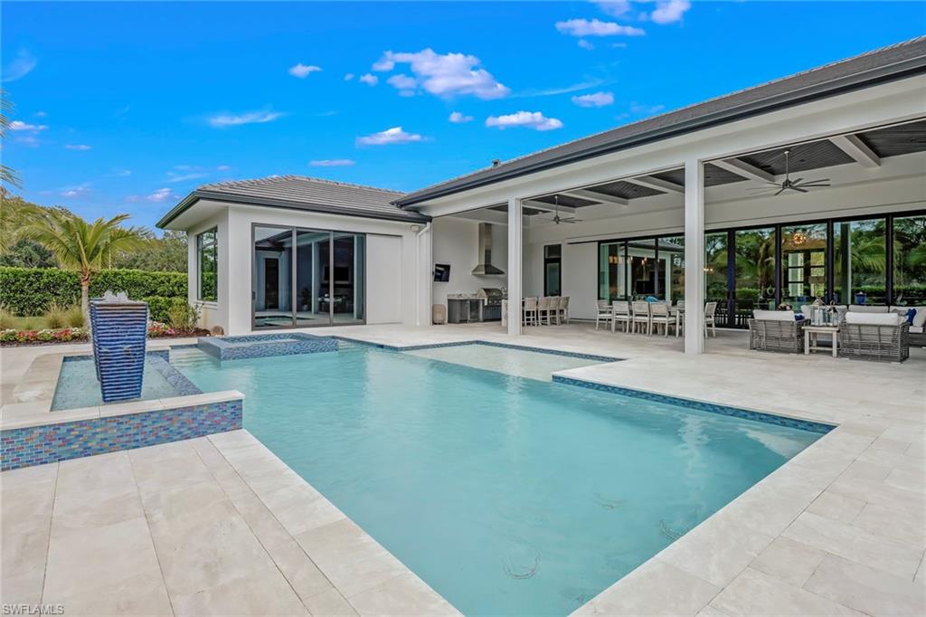 12 Banyan Road Naples, FL 34108 - Photo 39 of 44 a view of a patio with swimming pool table and chairs