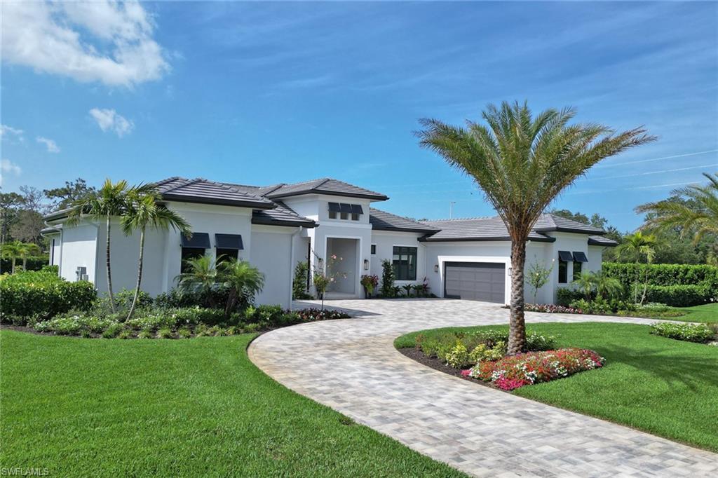 12 Banyan Road Naples, FL 34108 - Photo 42 of 44 a front view of a house with garden