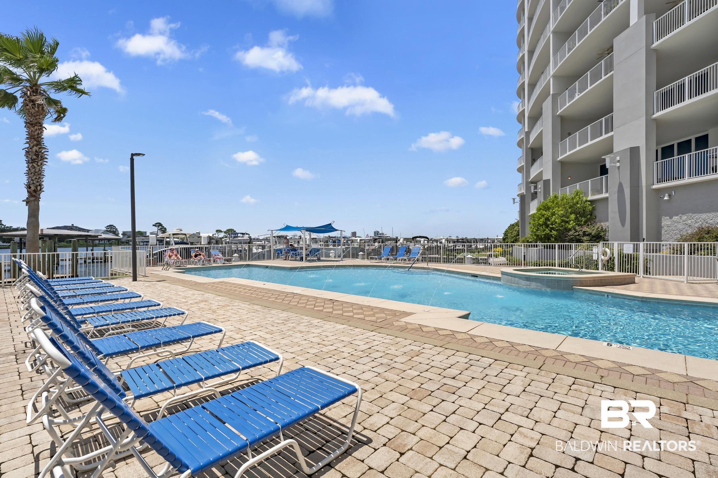 28250 Canal Road, Unit 307 Orange Beach, AL 36561 - Photo 12 of 56 Community pool featuring a hot tub and a patio area