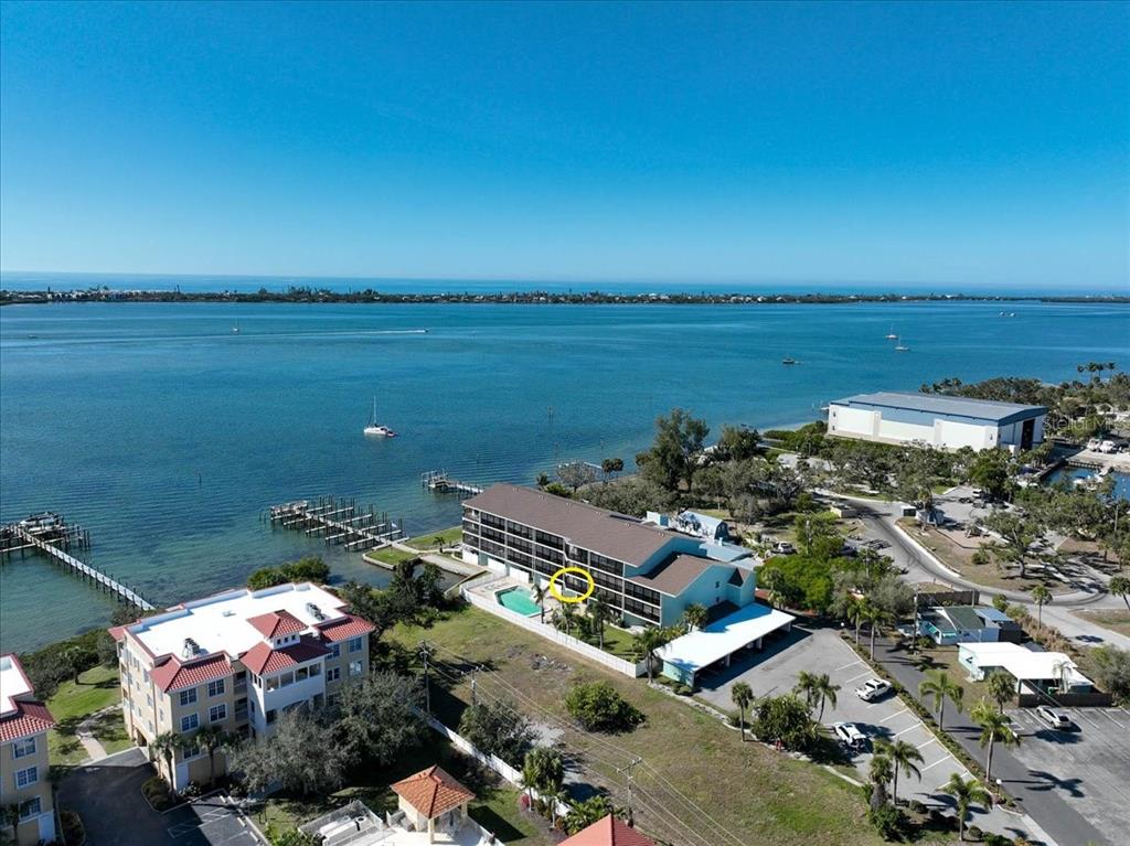 53 West Bay Heights Road, Unit 205 Englewood, FL 34223 - Photo 1 of 43 an aerial view of a city with lots of residential buildings and ocean view in back