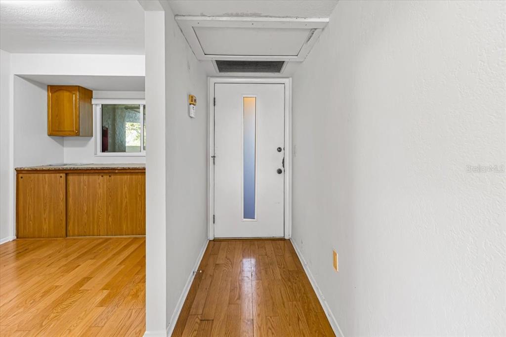 53 West Bay Heights Road, Unit 205 Englewood, FL 34223 - Photo 19 of 43 a view of a hallway with wooden floor and a bathroom