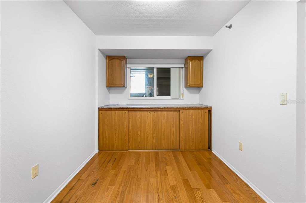 53 West Bay Heights Road, Unit 205 Englewood, FL 34223 - Photo 22 of 43 a view of a room with wooden floor and a window