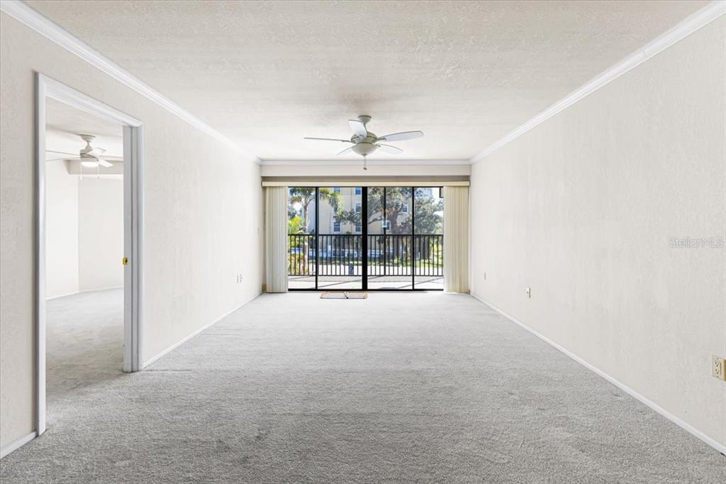 53 West Bay Heights Road, Unit 205 Englewood, FL 34223 - Photo 24 of 43 an empty room with windows and a ceiling fan