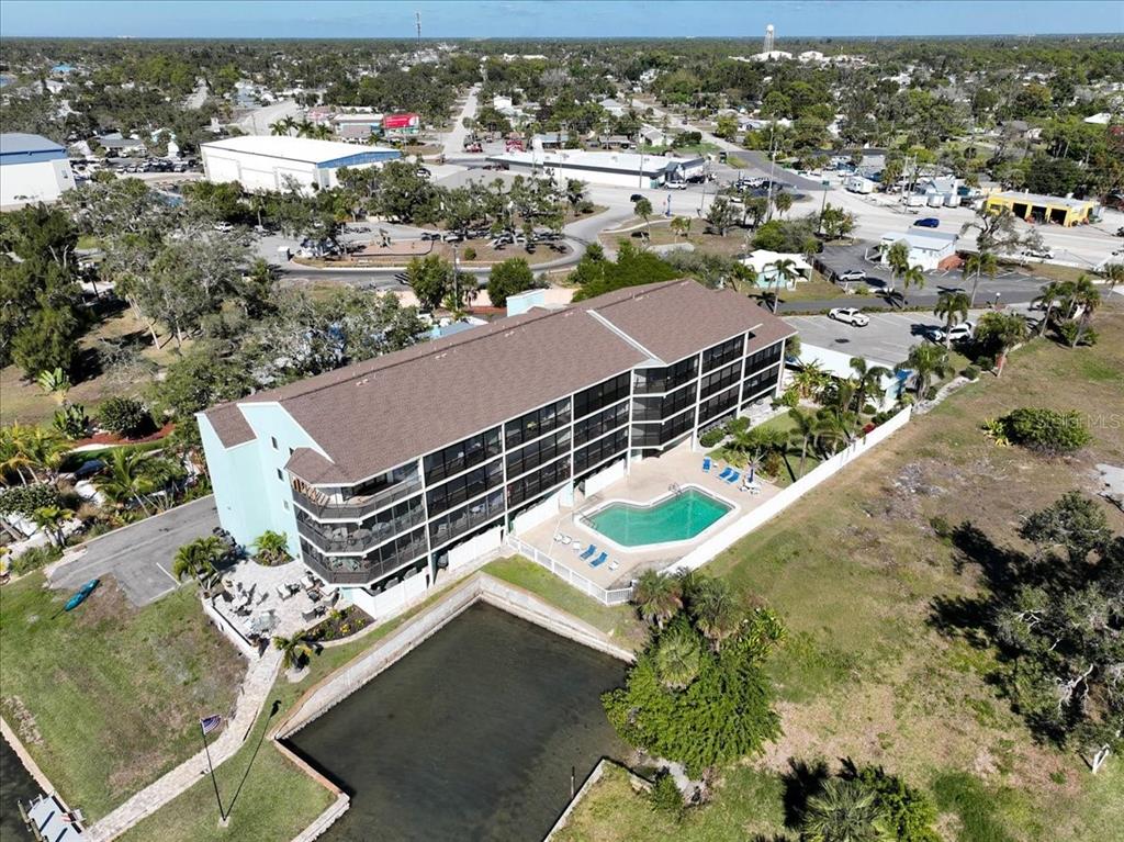 53 West Bay Heights Road, Unit 205 Englewood, FL 34223 - Photo 39 of 43 an aerial view of residential houses with outdoor space