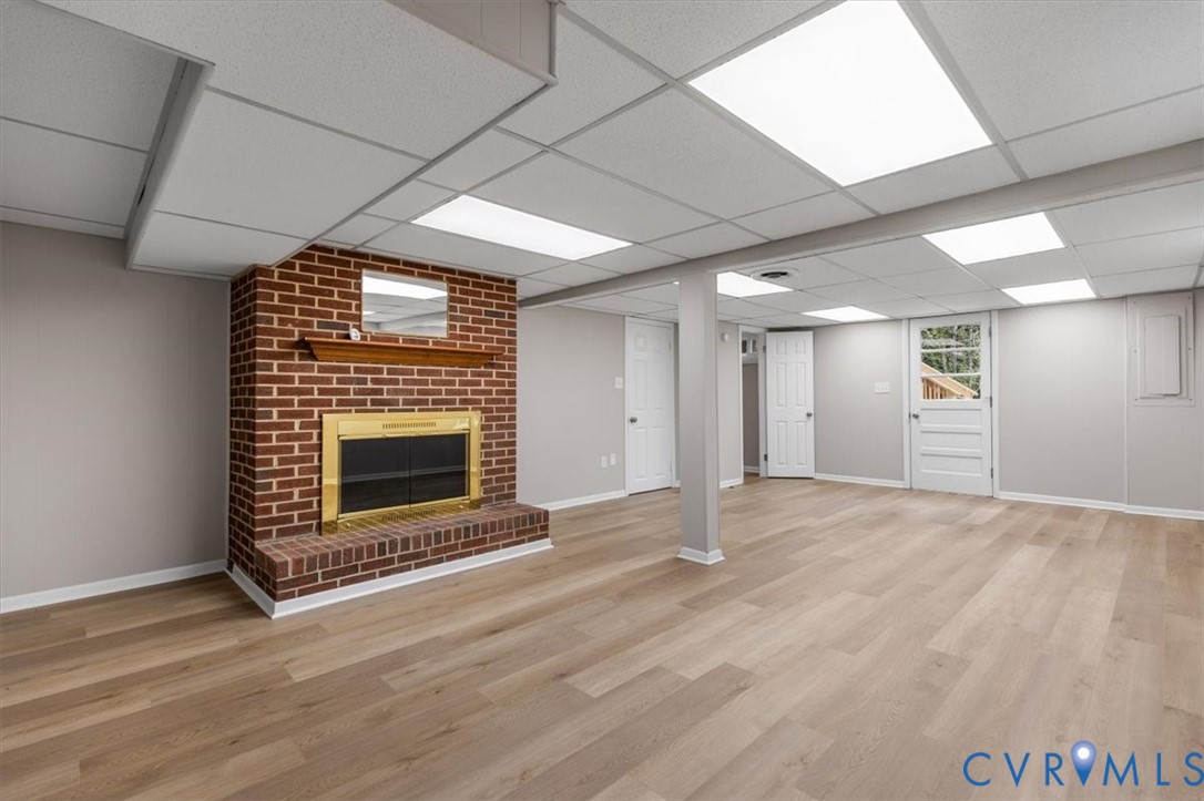3308 Sylvania Road Chester, VA 23831 - Photo 42 of 55 Expansive finished room featuring a brick fireplac