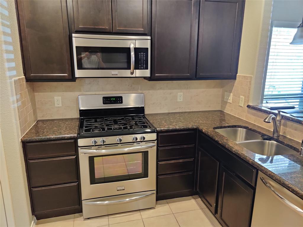 9901 Pronghorn Road McKinney, TX 75071 - Photo 14 of 27 a kitchen with granite countertop cabinets and steel stainless steel appliances