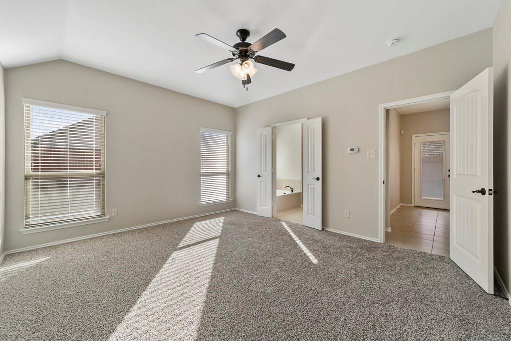 9901 Pronghorn Road McKinney, TX 75071 - Photo 16 of 27 a view of empty room with wooden floor and ceiling fan